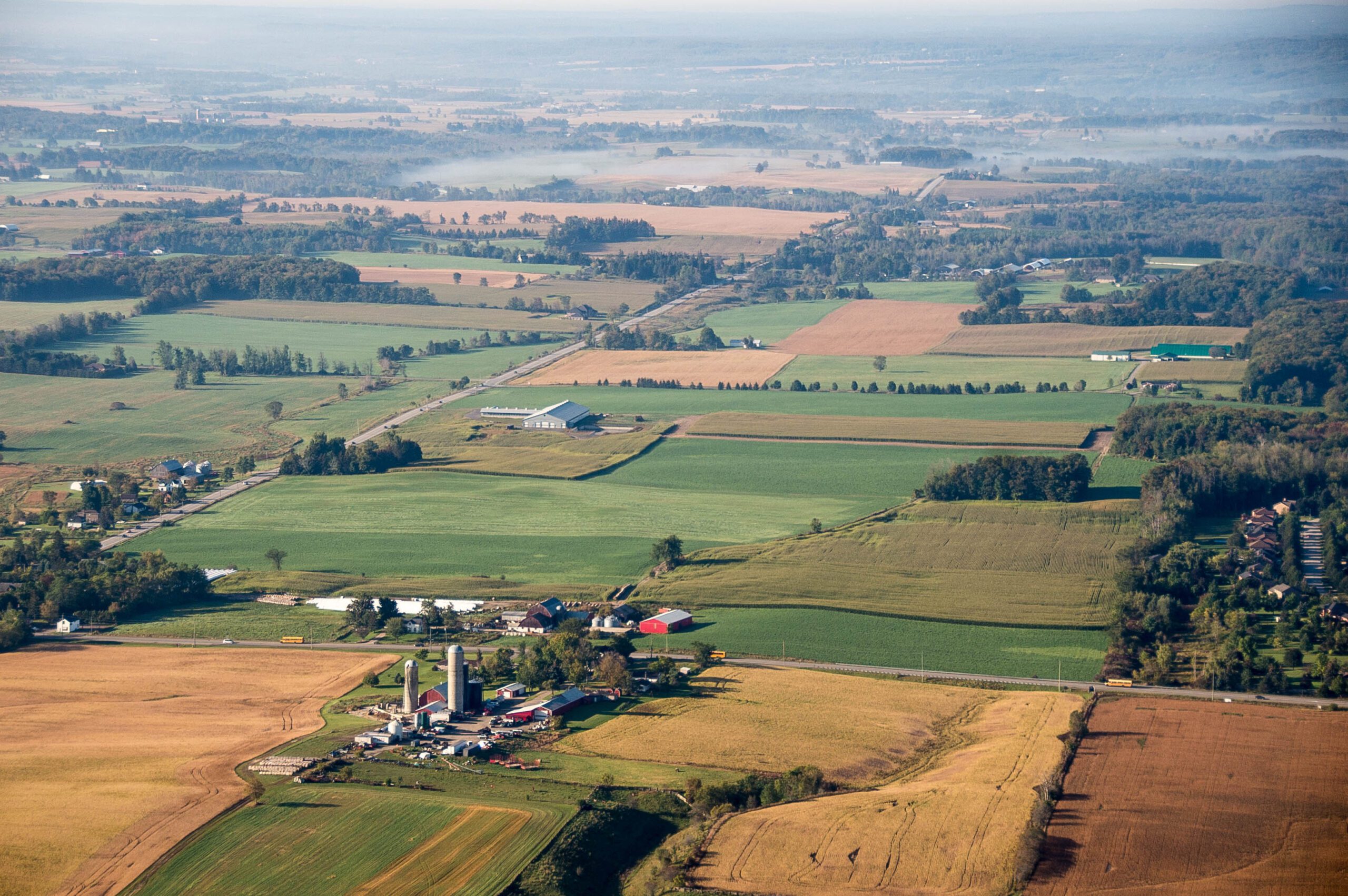 aerial image of farm field centering a farm property